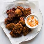 Beetroot Pakoras with Yogurt Chilli Dip | Raising Sugar Free Kids - a delicious gluten free vegan snack that is perfect for snacks or lunchboxes and a great Halloween treat with a 'blood' red colour and web-like appearance. Crispy, sweetly spiced and yummy. #glutenfree #halloween #vegan