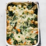 Cauliflower, Kale & Sweet Potato Gnocchi Bake | Raising Sugar Free Kids - a delicious creamy, filling pasta bake that is gluten free, has a vegan option and is packed full of winter veg. Perfect for batch-cooking and sticking in the freezer for a couple of quick easy family meals. #sugarfree #glutenfree #vegan